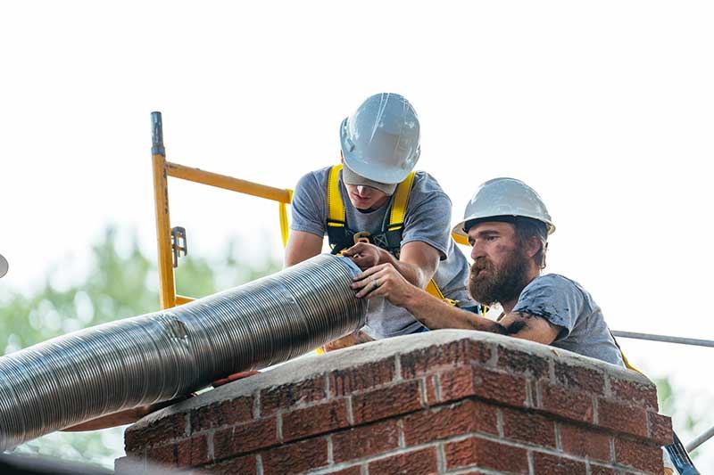 Stainless chimney liner installation for a wood-burning fireplace