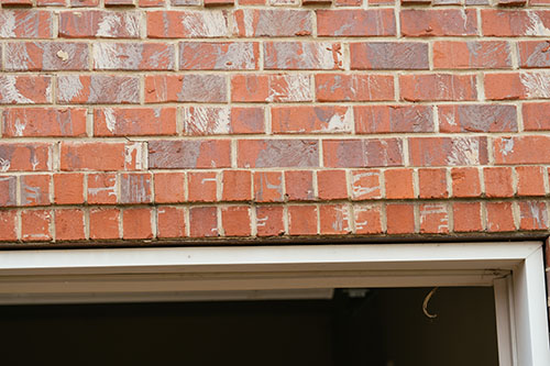 Cracked masonry above garage door - Madewell Masonry2