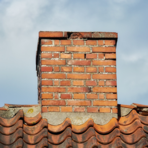 masonry chimney with some bricks and mortar missing