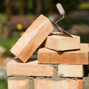 a stack of bricks with a masonry tool on top